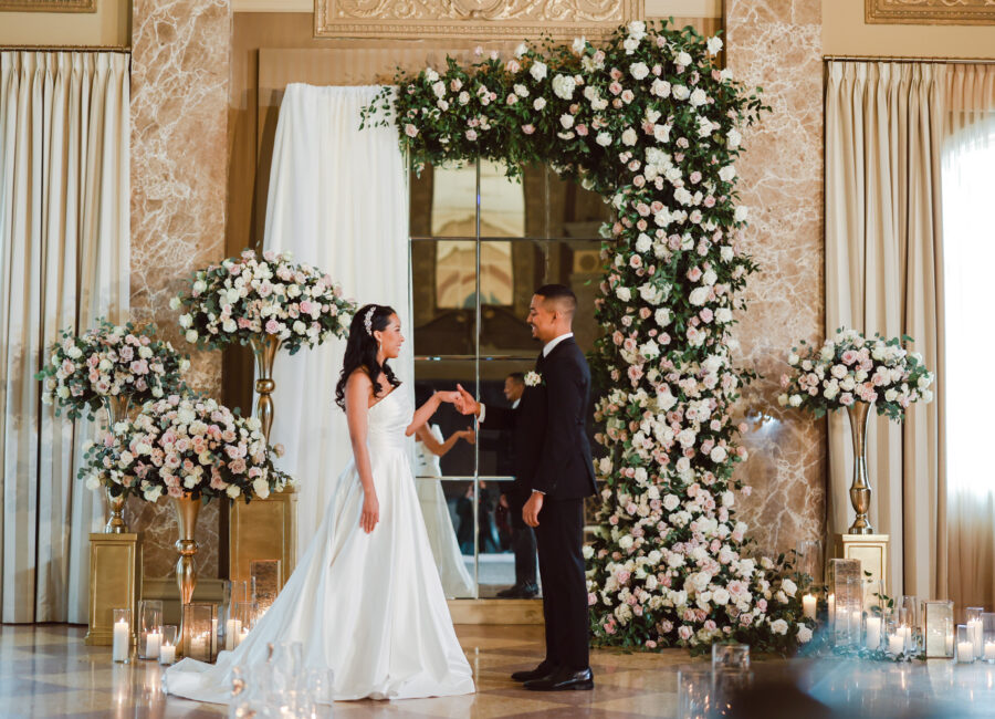 Bride and groom at floral altar