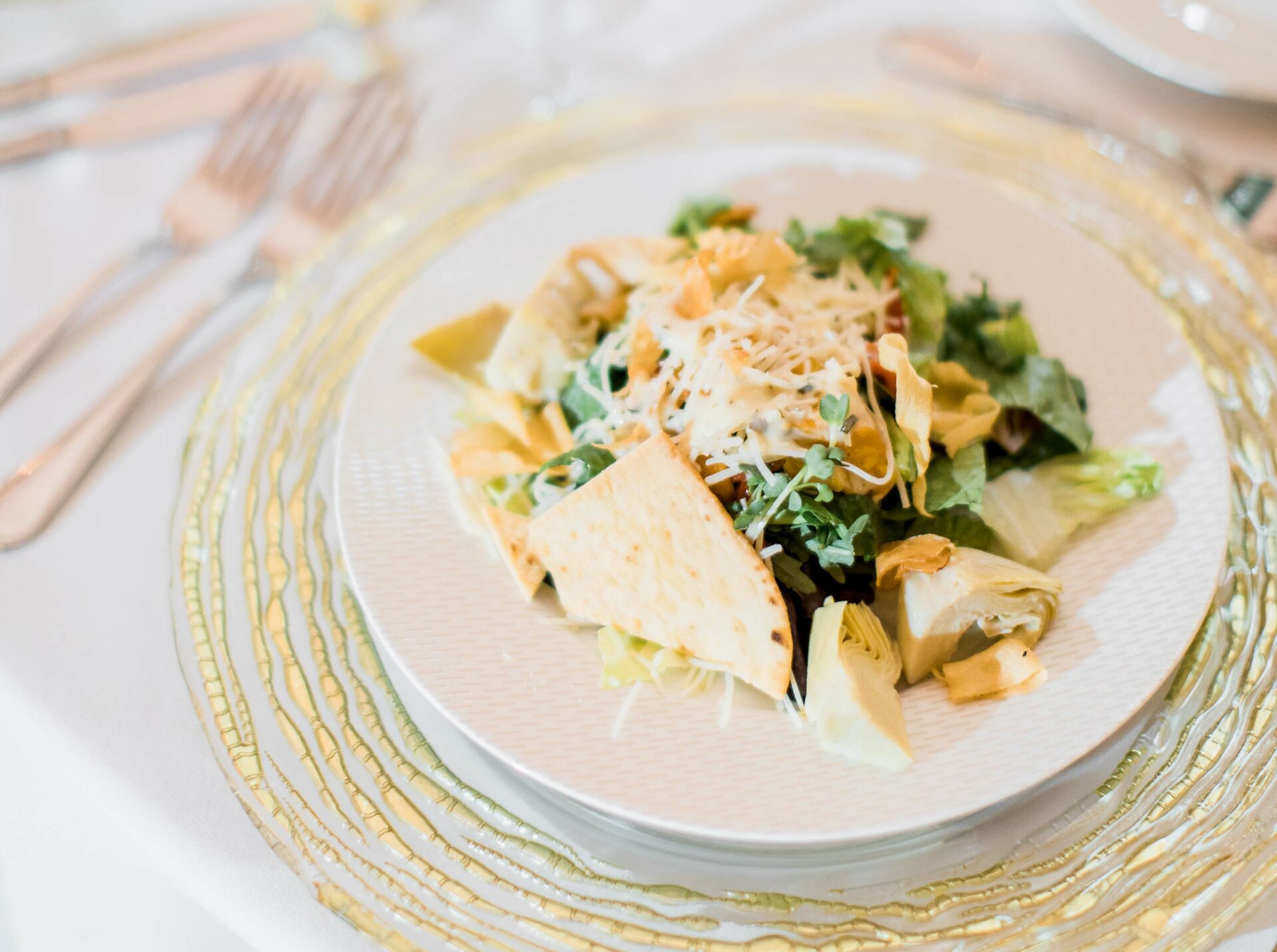 Cheese topped salad on ornate golden placemat