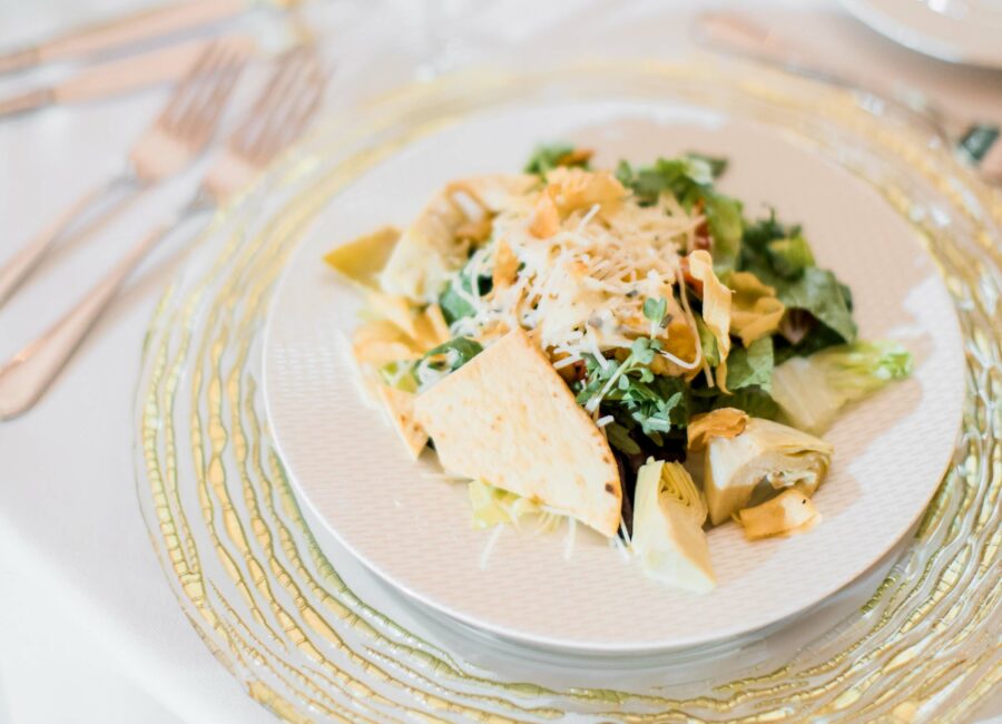 Cheese topped salad on ornate golden placemat