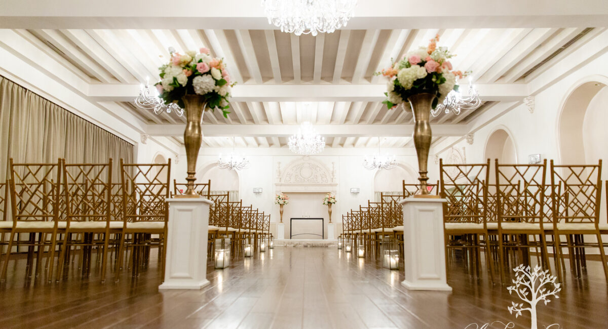 Intimate white ballroom set up for a wedding ceremony